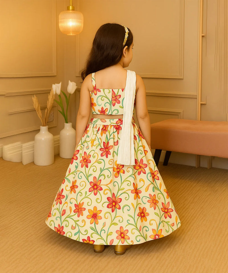 Young girl wearing a floral dress in a room with beige walls and a vase of flowers.