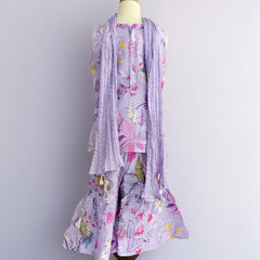 Floral dress with matching scarf on a mannequin against a plain background