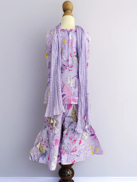 Floral dress with matching scarf on a mannequin against a plain background
