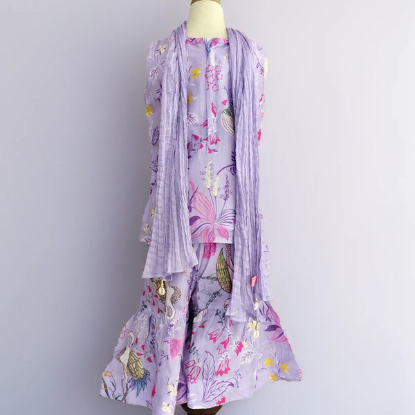 Floral dress with matching scarf on a mannequin against a plain background