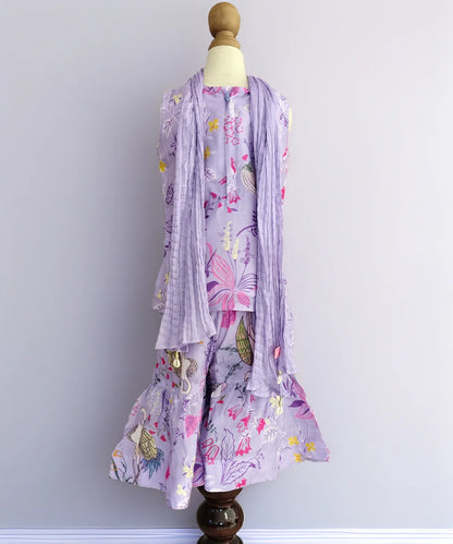 Floral dress with matching scarf on a mannequin against a plain background