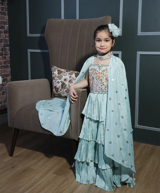 This sea-green coloured kids lehengas consist of a frill lehenga, a choli and a long wing style dupatta. It features embroidered detailing on the choli and on the neck of the dupatta. Moreover, It also features sequin work detailing on the dress.
