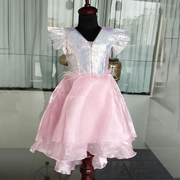 Pink and white dress on a mannequin against a neutral background