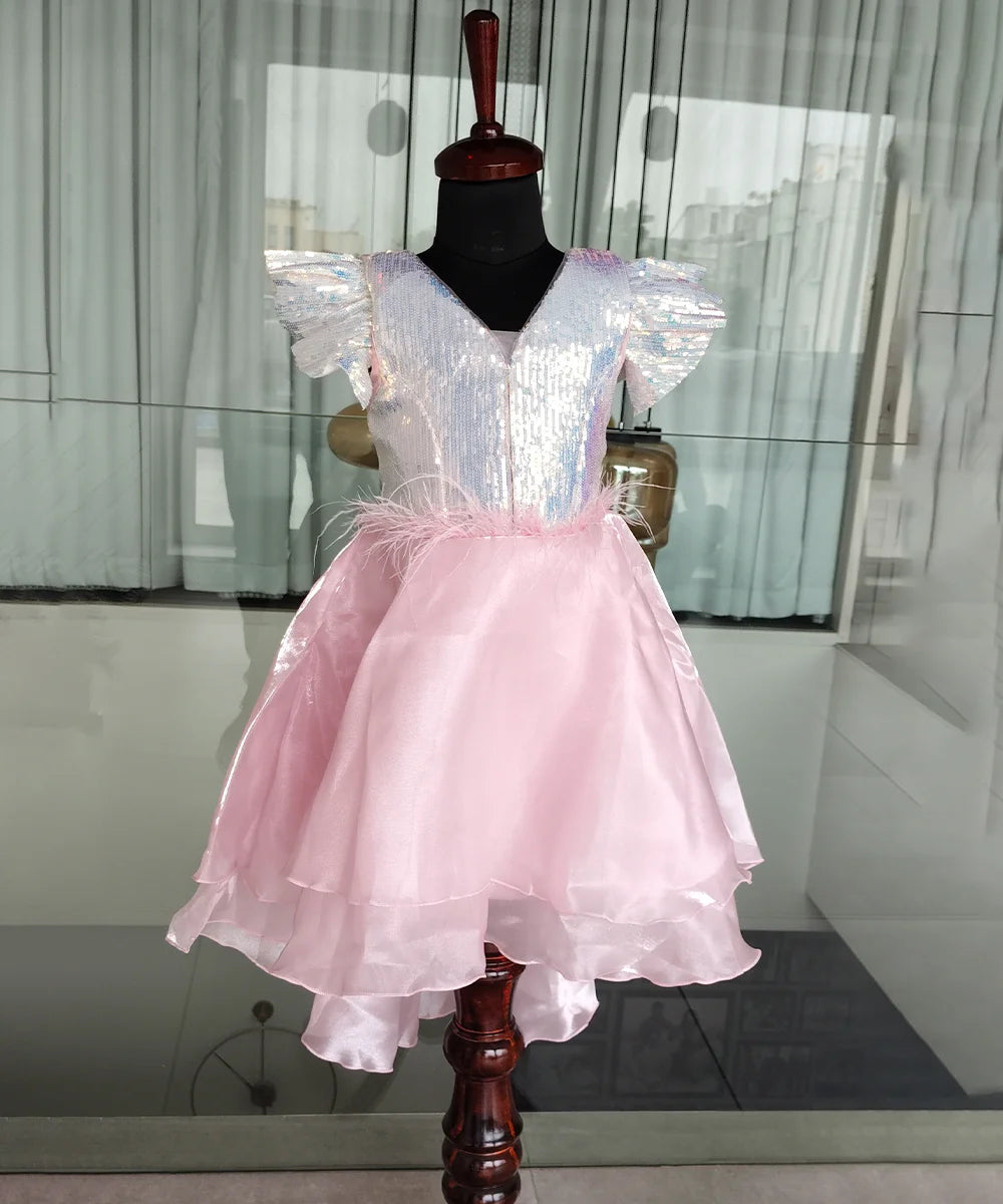 Pink and white dress on a mannequin against a neutral background