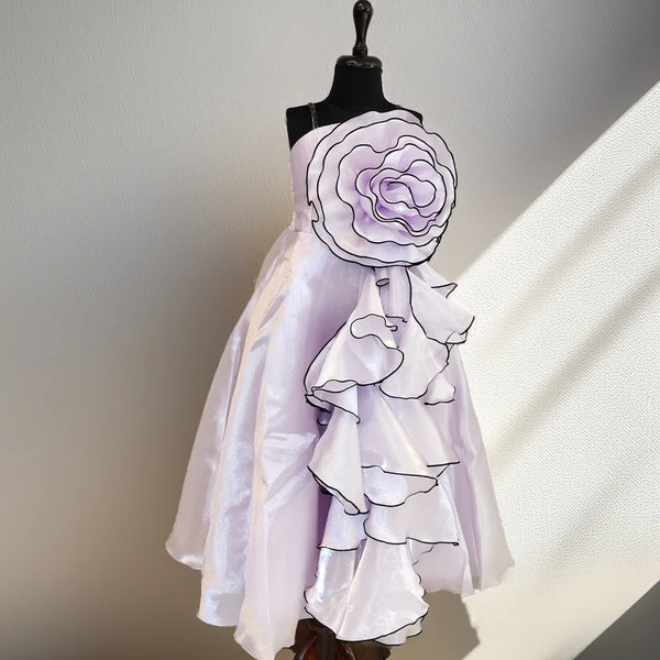 White dress with floral details on a mannequin against a neutral background