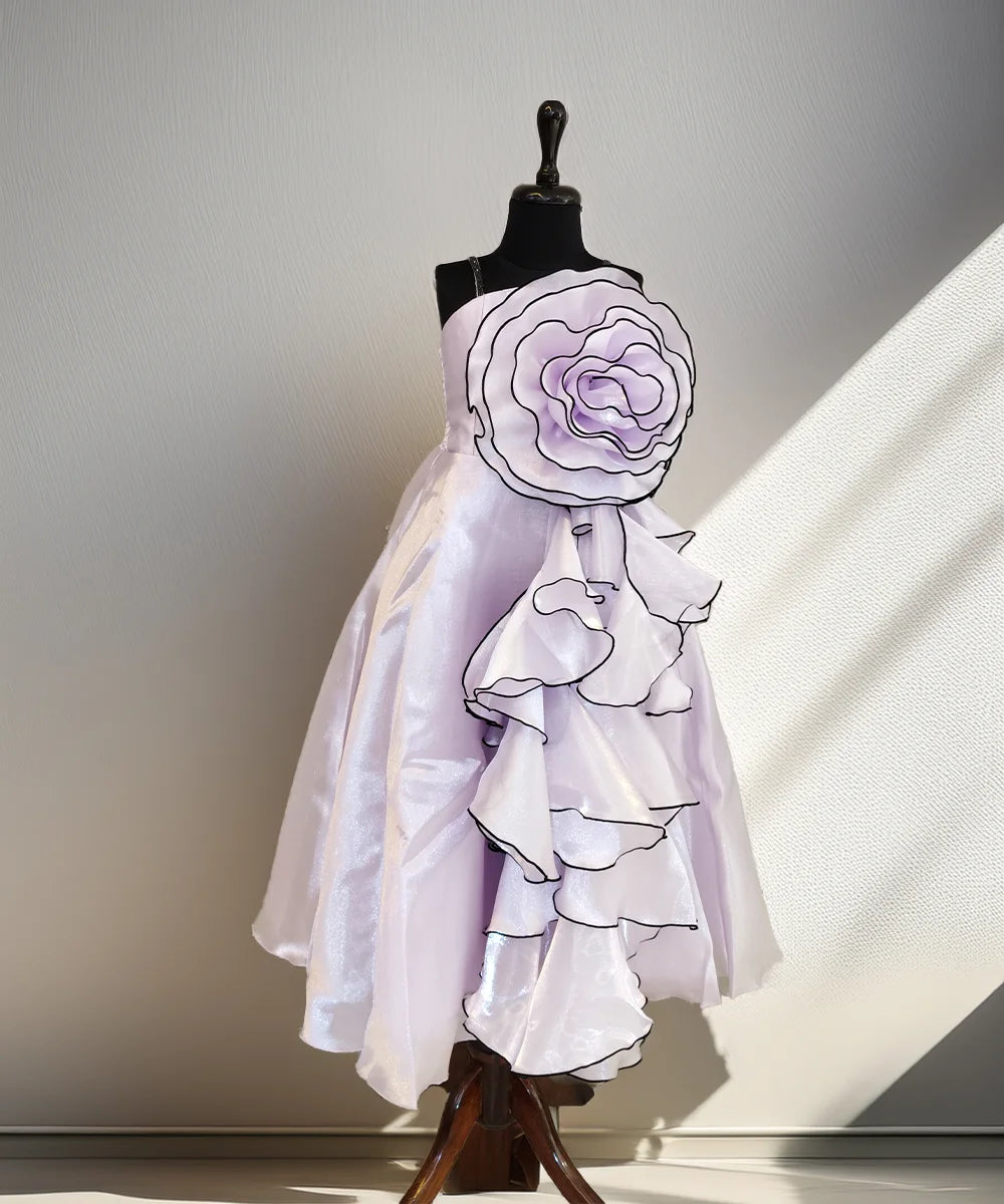 White dress with floral details on a mannequin against a neutral background