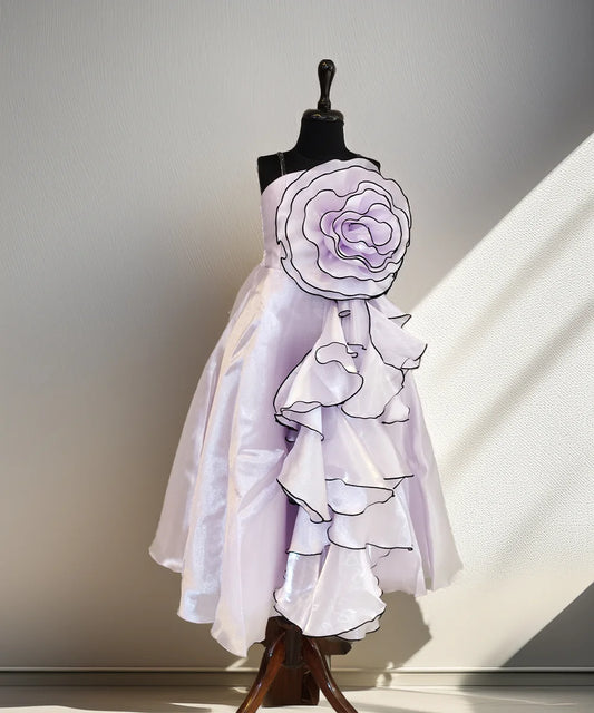 White dress with floral details on a mannequin against a neutral background