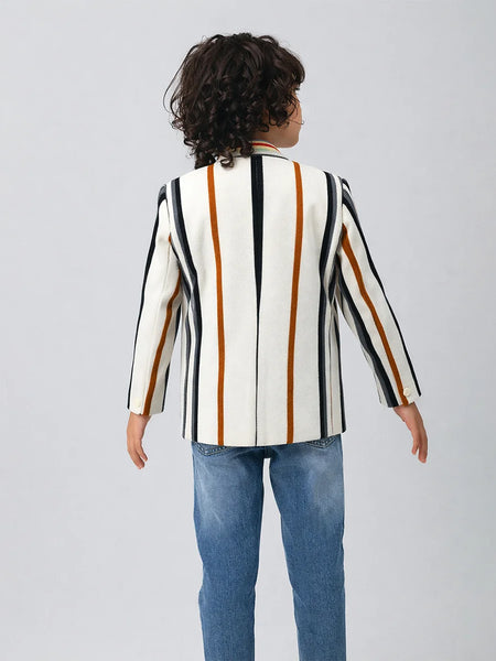 Child wearing a striped blazer over a graphic t-shirt on a plain background