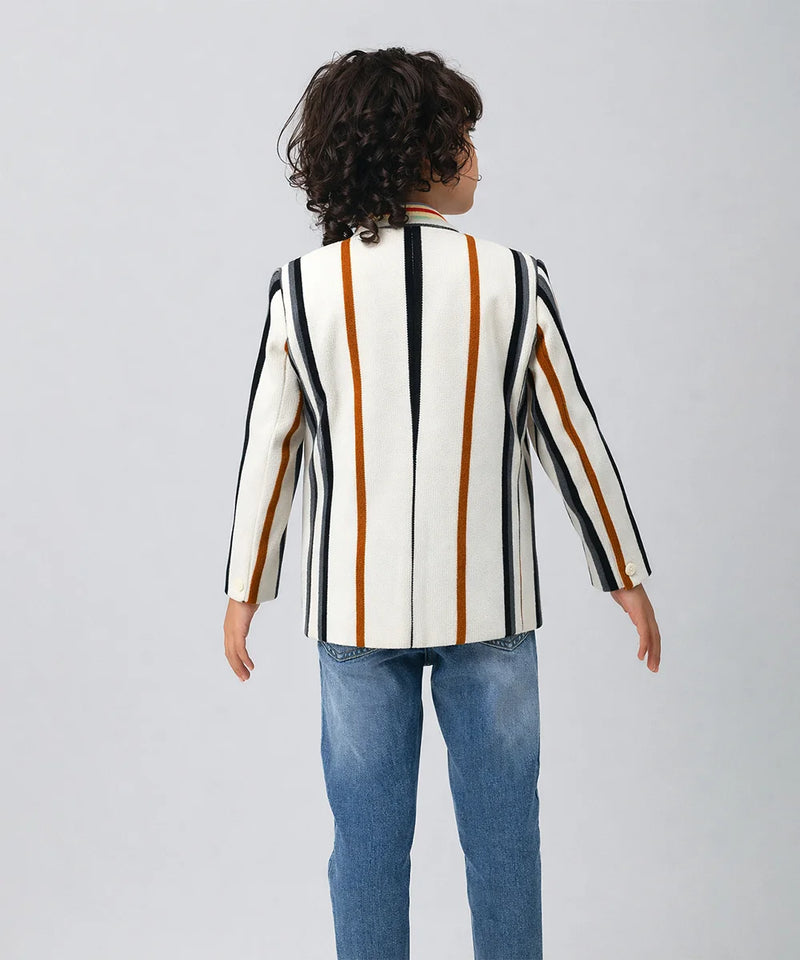 Child wearing a striped blazer over a graphic t-shirt on a plain background