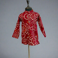  It is a maroon Coloured smart bhandej print kurta pyjama set that creates a spotlight of its own.