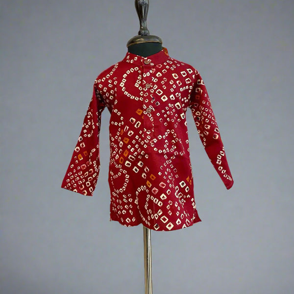  It is a maroon Coloured smart bhandej print kurta pyjama set that creates a spotlight of its own.