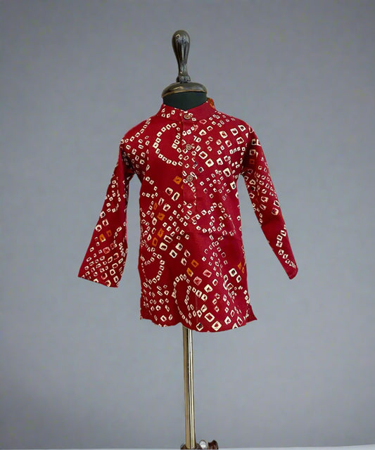  It is a maroon Coloured smart bhandej print kurta pyjama set that creates a spotlight of its own.