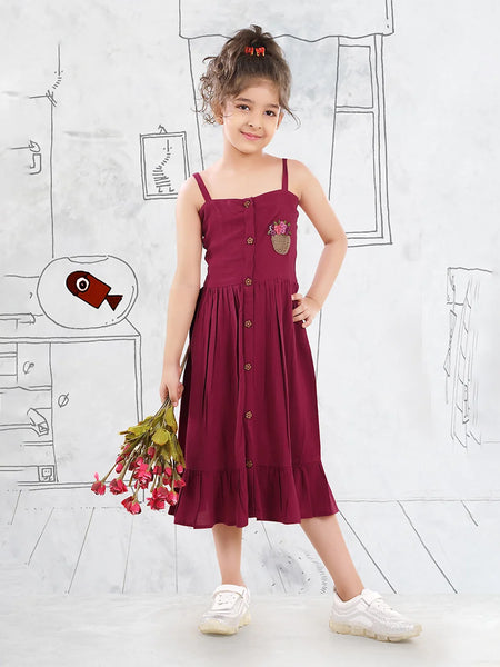 It is a Maroon Colored birthday girl frock that comes with a front button closure for girls. It features beautiful floral basket embroidery on the dress.