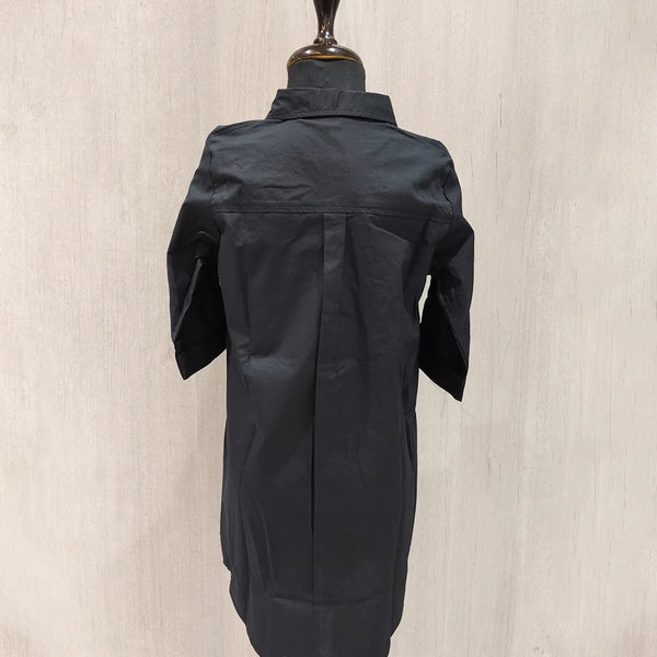 Black jacket on a mannequin against a beige background