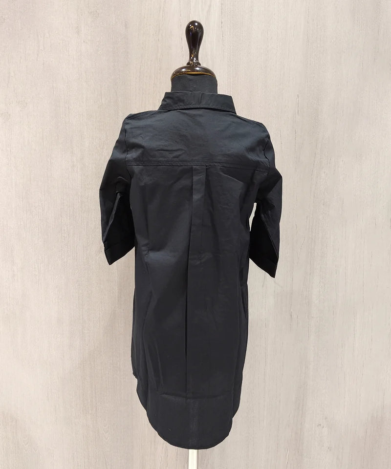 Black jacket on a mannequin against a beige background