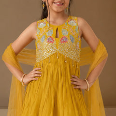 Mustard yellow ethnic outfit for girls with net dupatta.