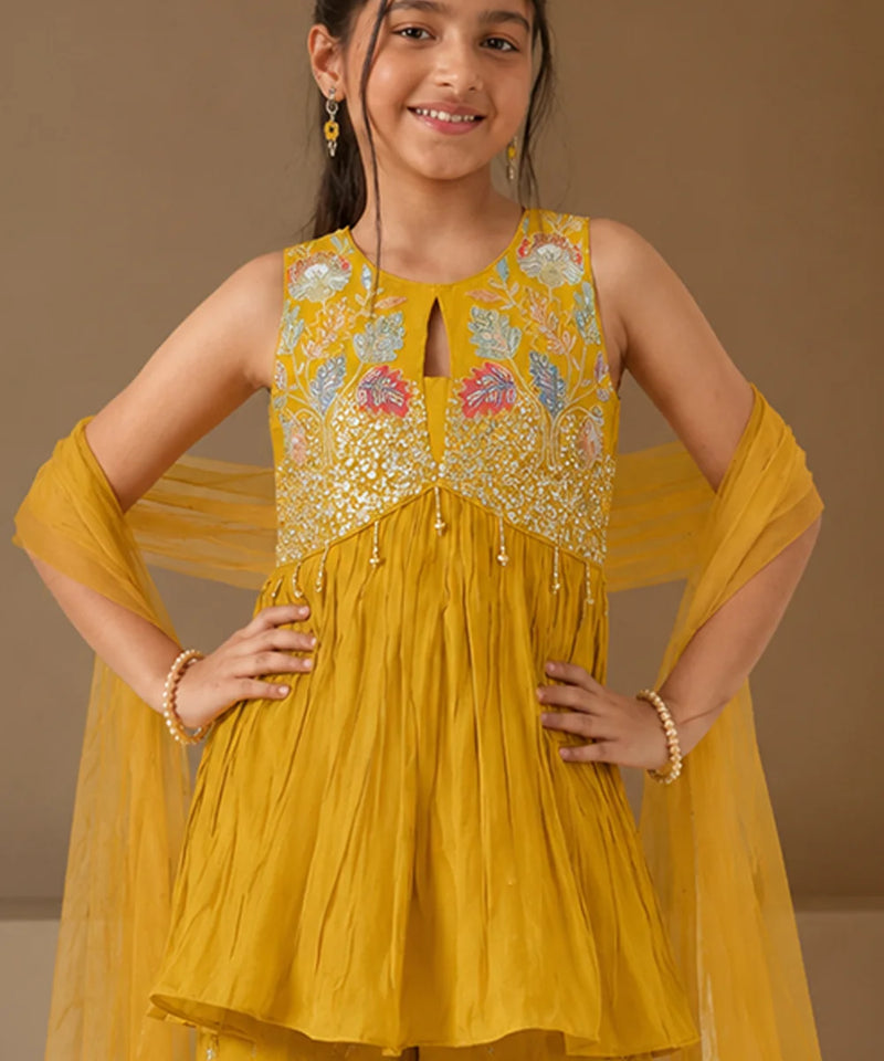 Mustard yellow ethnic outfit for girls with net dupatta.