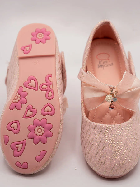 Close-up of newborn pink glitter party shoes with embellished bow and cushioned insole, Jaipur