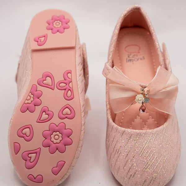 Close-up of newborn pink glitter party shoes with embellished bow and cushioned insole, Jaipur