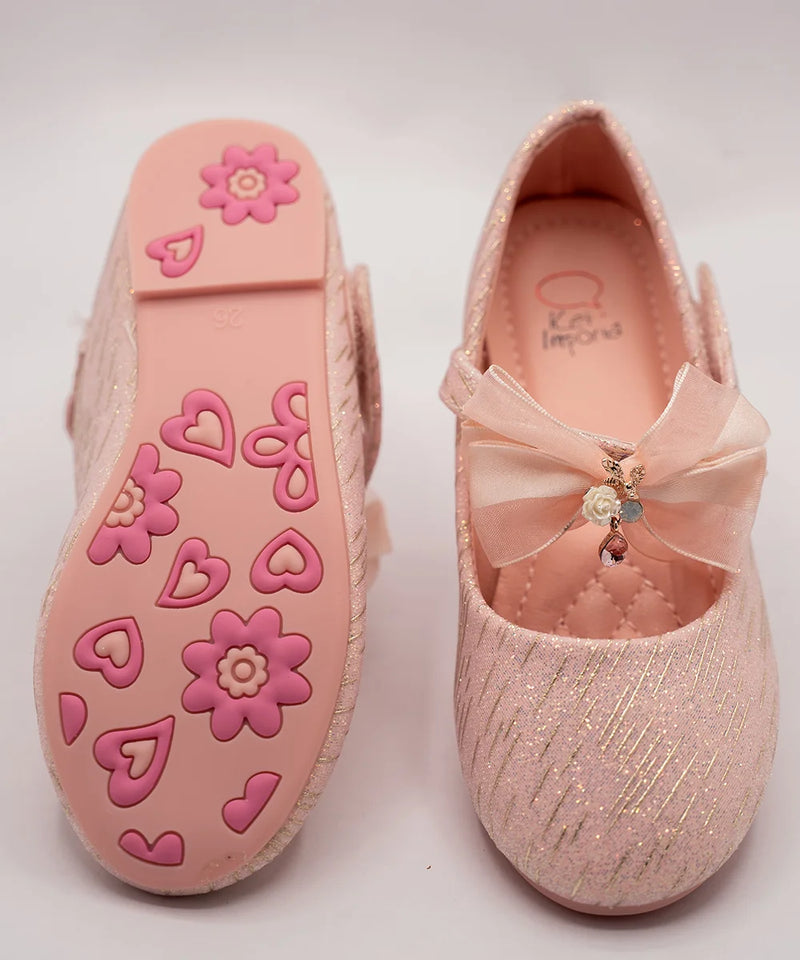Close-up of newborn pink glitter party shoes with embellished bow and cushioned insole, Jaipur