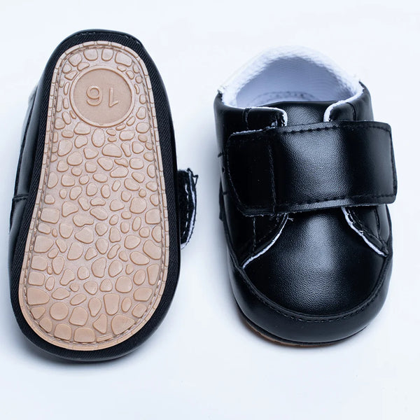 Close-up of newborn unisex black sports shoes with Velcro closure, Jaipur