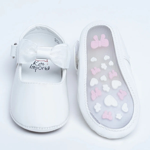 Close-up of newborn white shoes with soft bow accent and cushioned insole, Jaipur