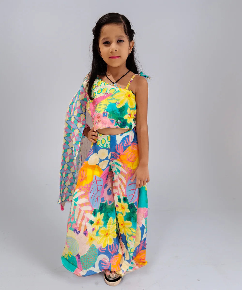 Young girl wearing a colorful floral dress on a plain background