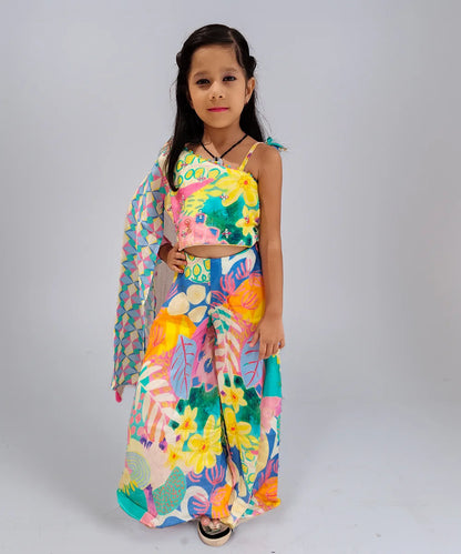 Young girl wearing a colorful floral dress on a plain background