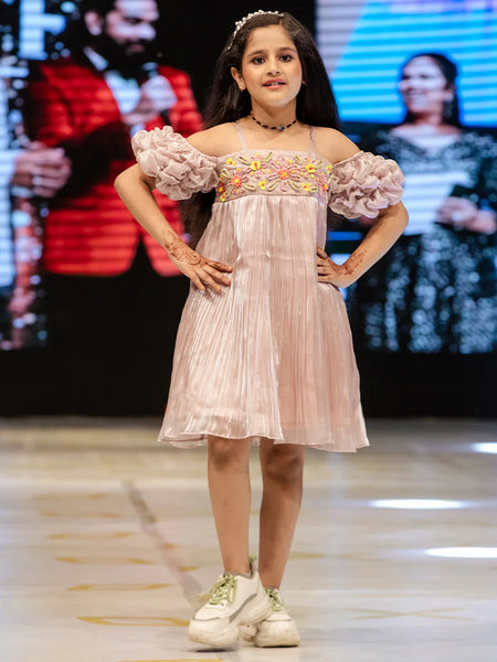 It’s a very light onion pink Colored girl party dress online that’s perfect for occasions. It features designer floral work and a smocking sleeves