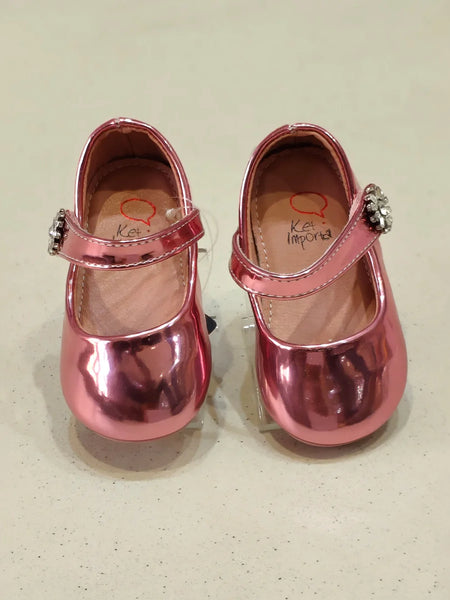Close-up of toddler girls' shiny pink party flats featuring gem strap and rounded toe, Jaipur

