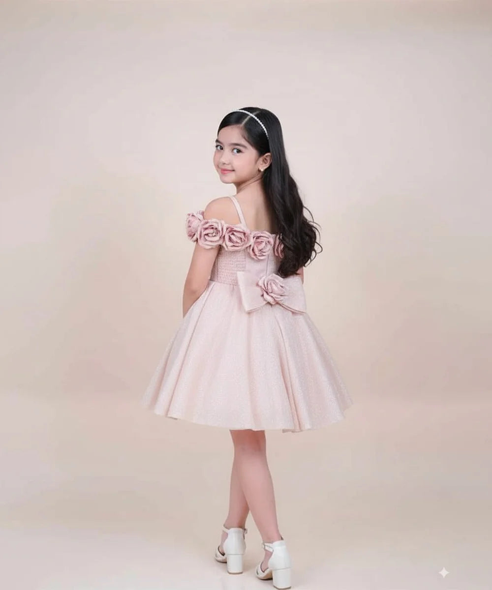Young girl wearing a pink dress with floral details on a beige background