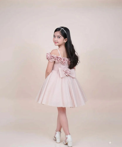 Young girl wearing a pink dress with floral details on a beige background