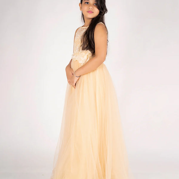 Young girl wearing a light yellow dress with floral details on a white background