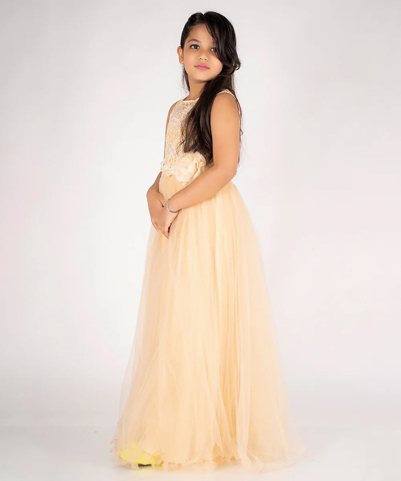 Young girl wearing a light yellow dress with floral details on a white background