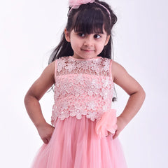 Young girl wearing a pink floral dress against a white background