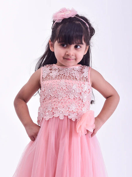 Young girl wearing a pink floral dress against a white background