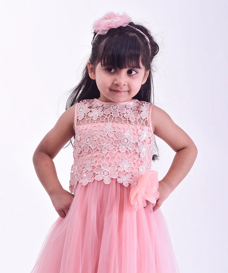 Young girl wearing a pink floral dress against a white background