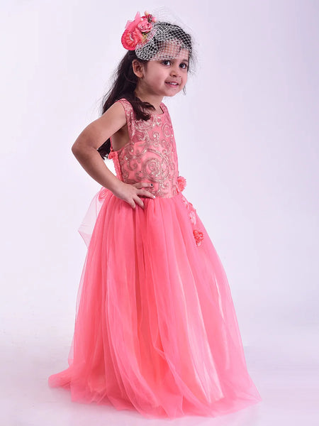 Young girl in a pink dress with floral headband on a white background