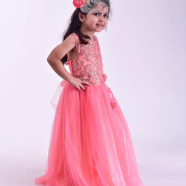 Young girl in a pink dress with floral headband on a white background