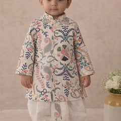 Child wearing a traditional embroidered outfit with a neutral background