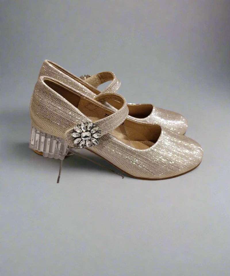 Close-up of girls' sparkling gold dress shoes with decorative gem detail and round toe, Jaipur

