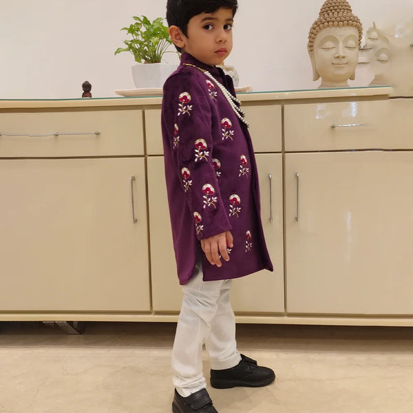 Side view of magenta color embroidery sherwani for boys for wedding with matching white pajama 