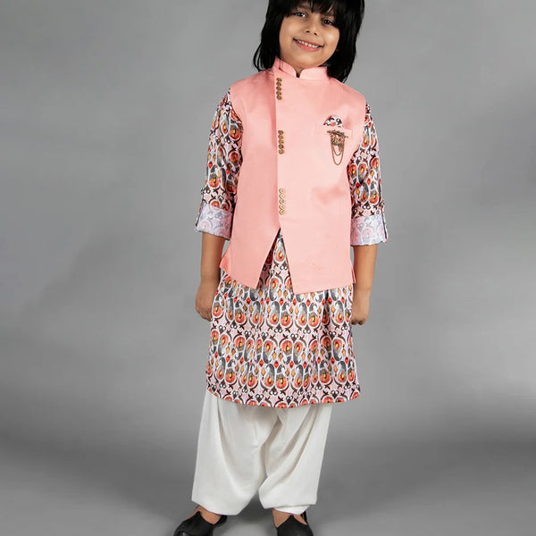 Representing this beautiful sleeveless solid jacket in peach with a golden broach and a pocket square, paired with a soft cotton blend kurta and matching cream colored Patiala.