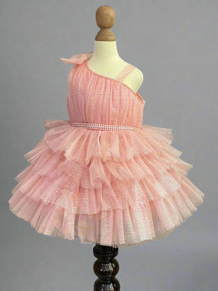 It's a peach Colored frock that features a cute bow on the shoulder and pearl belt attached on the waist.