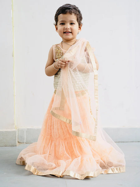 This traditional lehenga for kids consist of a choli, a tiered Lehenga and a dupatta for your kids with a back hook closure. It features embellished shoulder and choli. Moreover, skirt has a lace work on the waist and tassel detailing on it.