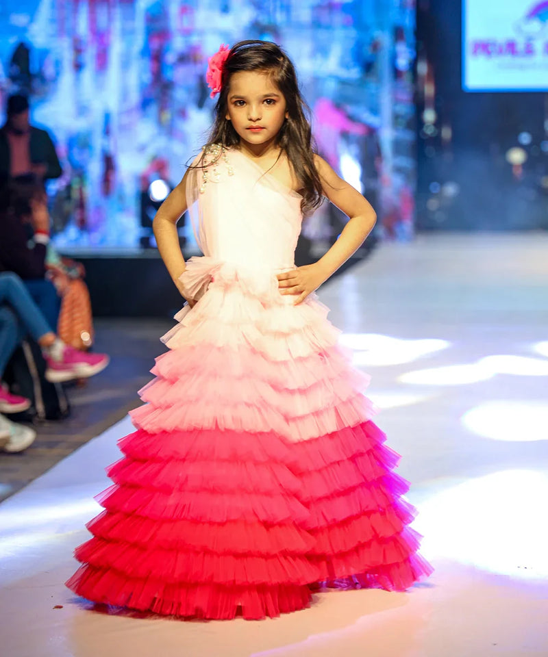 It’s a fancy ruffle gown that features a beautiful pearl detailing on the shoulder that uplifts the entire look.