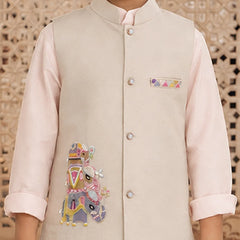 A child wearing a light beige embroidered waistcoat over a pale pink kurta, with a decorative geometric patterned background.