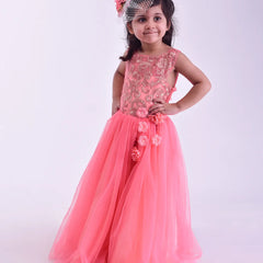 Young girl in a pink gown with floral details on a white background