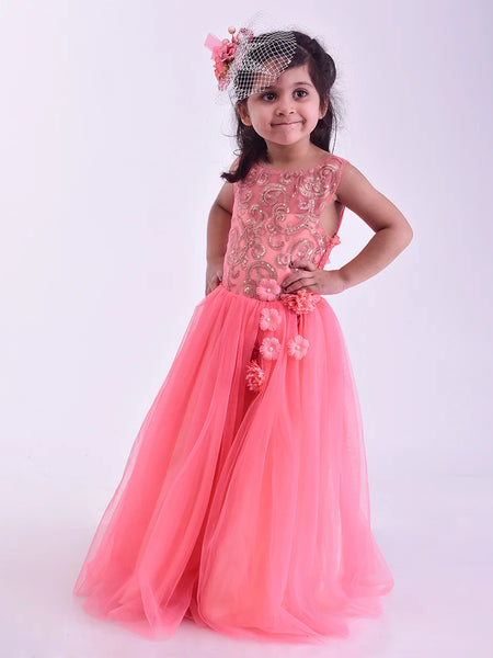 Young girl in a pink gown with floral details on a white background