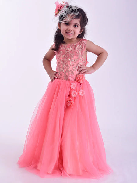 Young girl wearing a pink floral dress against a white background